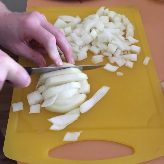 Chopping the onions for beef chilli in the slow cooker