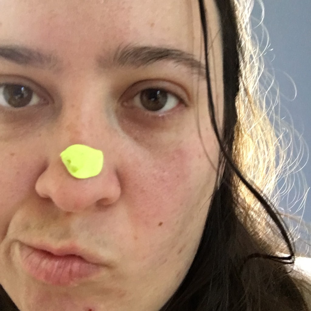 Yellow blue tack on nose selife
